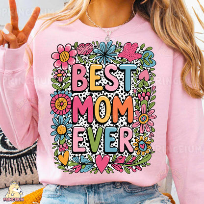 a woman wearing a pink sweatshirt that says best mom ever