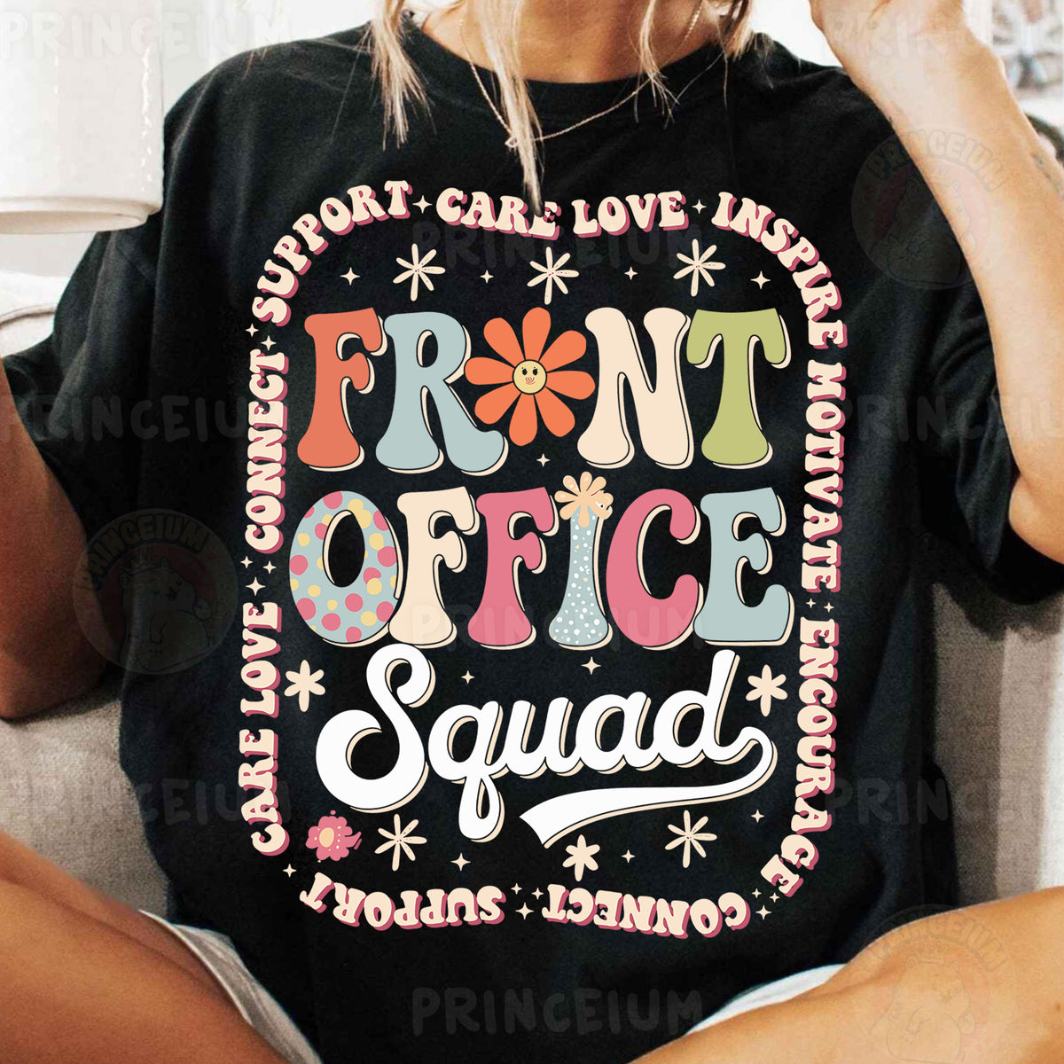 a woman sitting on a couch wearing a t - shirt that says front office squad