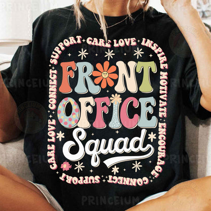 a woman sitting on a couch wearing a t - shirt that says front office squad