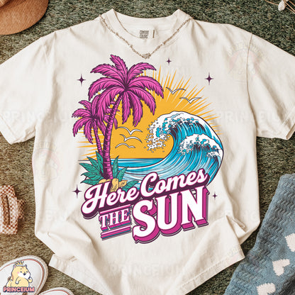 a t - shirt that says here comes the sun with a picture of a palm