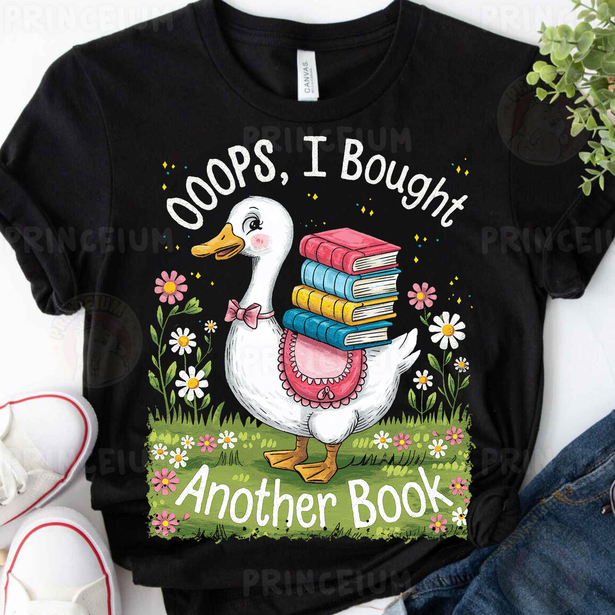 a black shirt with a duck holding a stack of books