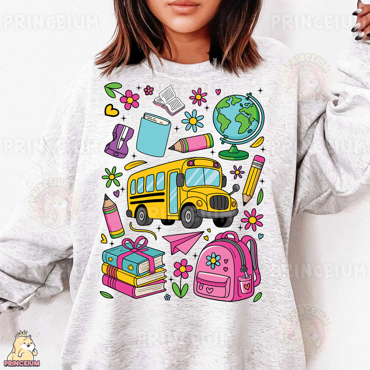 a woman wearing a sweatshirt with a school bus and books on it