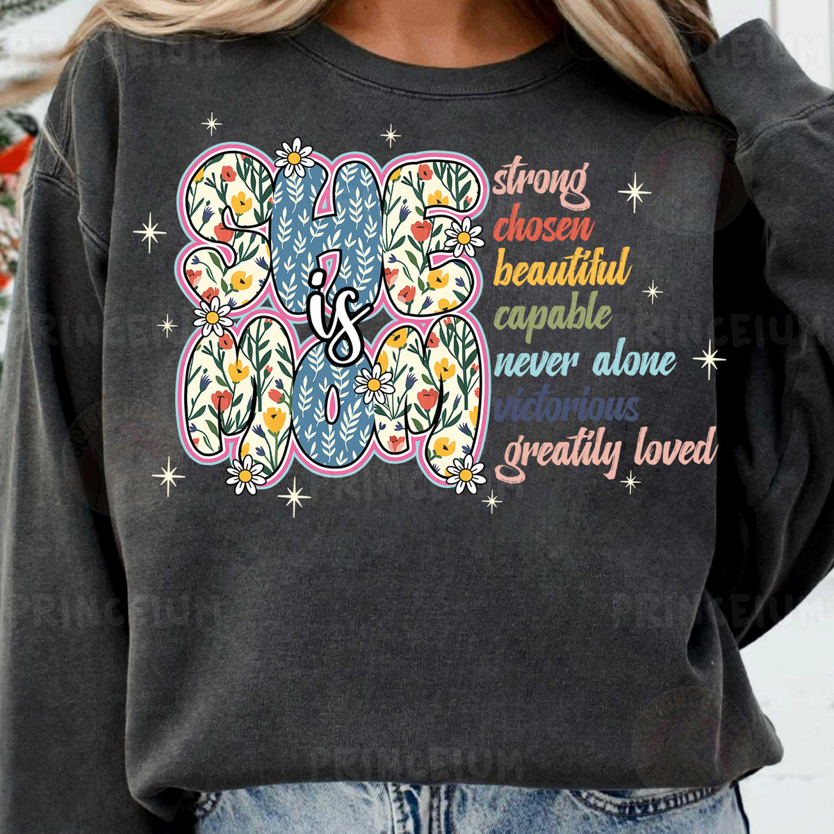 a woman wearing a black sweatshirt with a colorful flower design