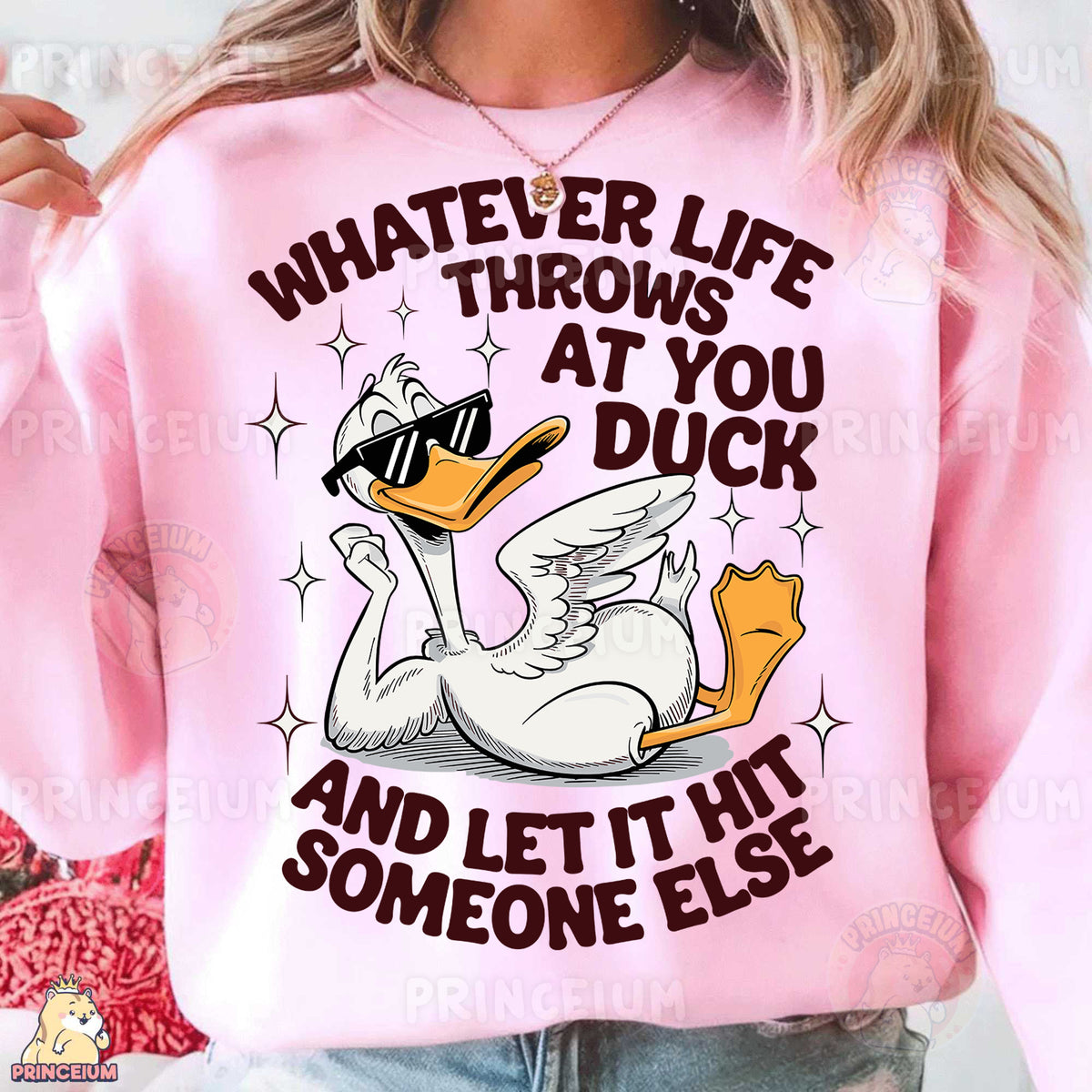 a woman wearing a pink sweater with a duck on it
