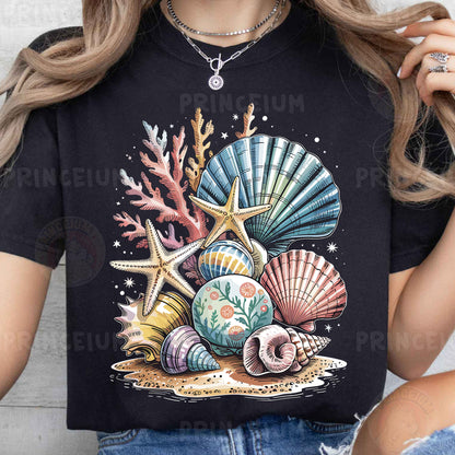 a woman wearing a t - shirt with seashells on it
