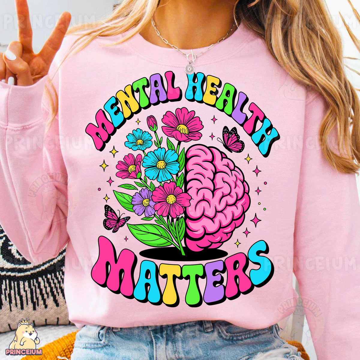 a woman wearing a pink sweatshirt with a flower design on it