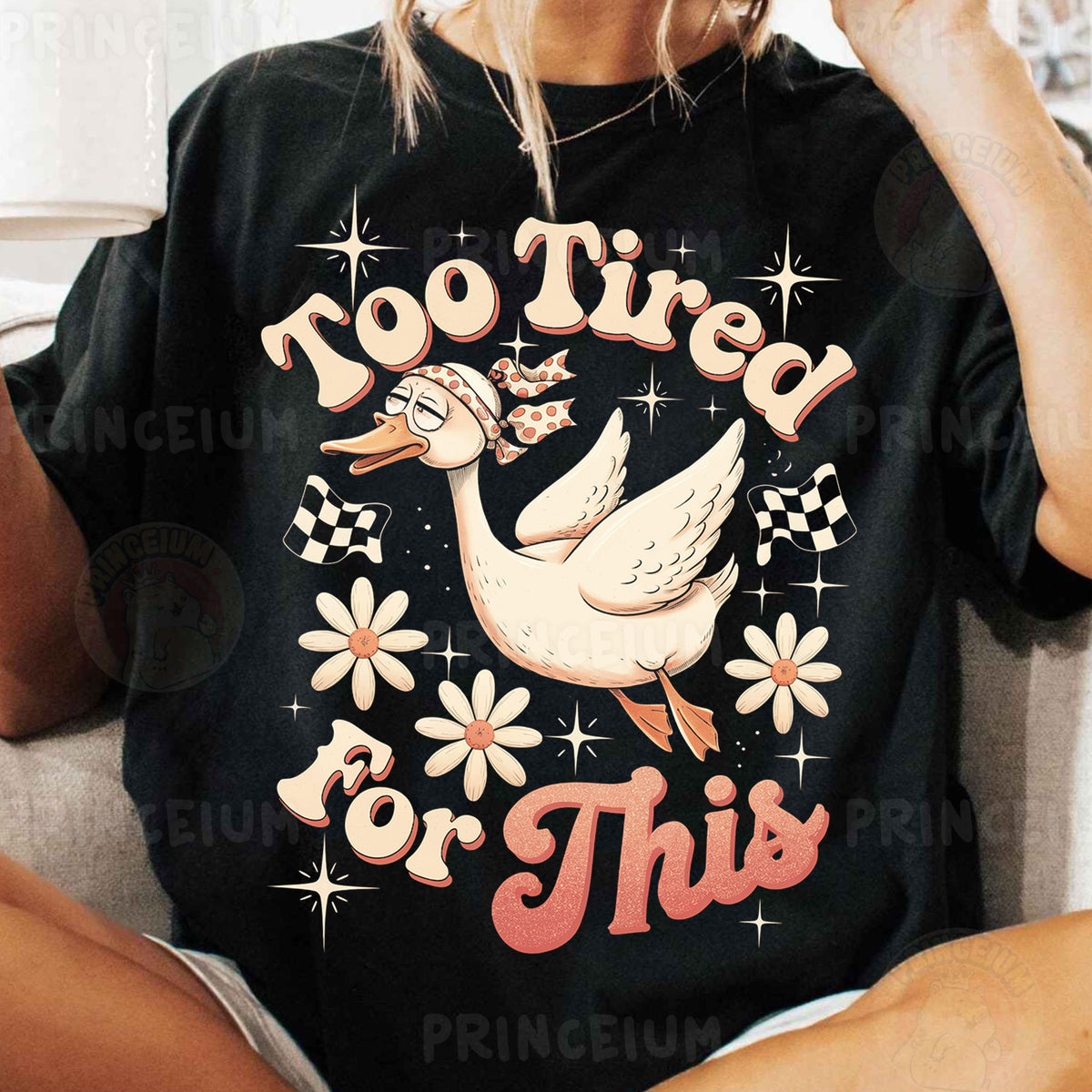 a woman sitting on a couch wearing a t - shirt that says no tired for