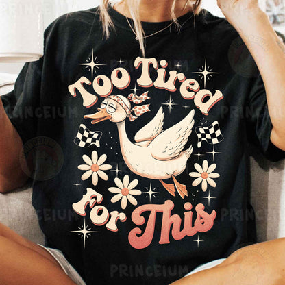 a woman sitting on a couch wearing a t - shirt that says no tired for