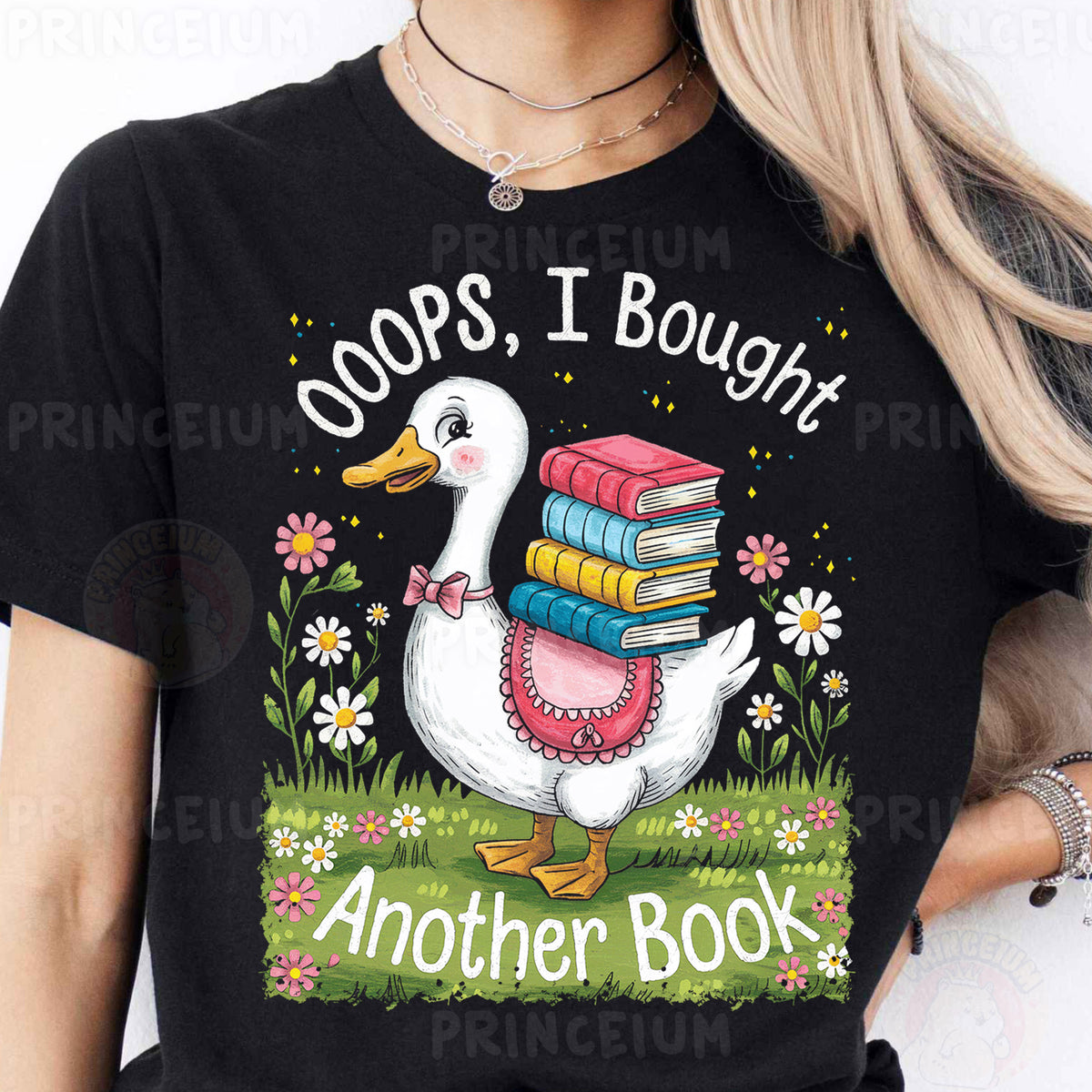 a woman wearing a black t - shirt with a goose holding a stack of books
