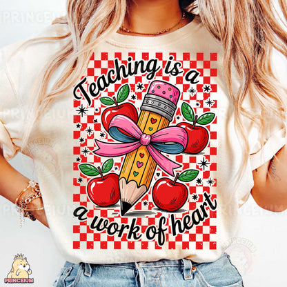 a woman wearing a t - shirt that says teaching is a work of heart