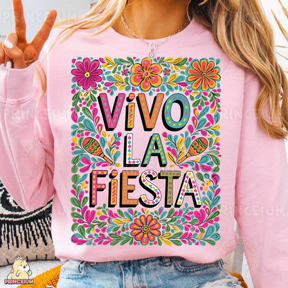 a woman wearing a pink shirt that says vivo la fiesta