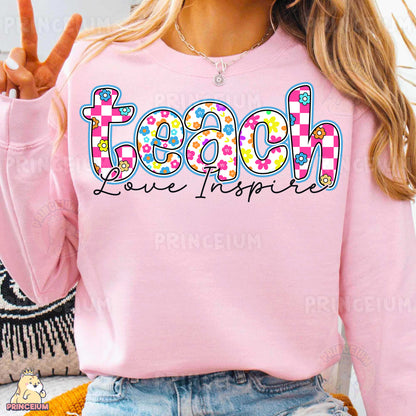 a woman wearing a pink sweatshirt with the word teach on it