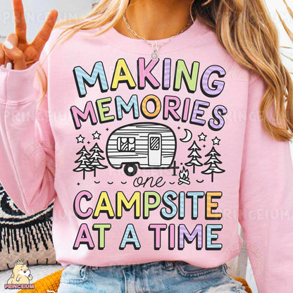 a woman wearing a pink shirt that says making memories is campsite at a time