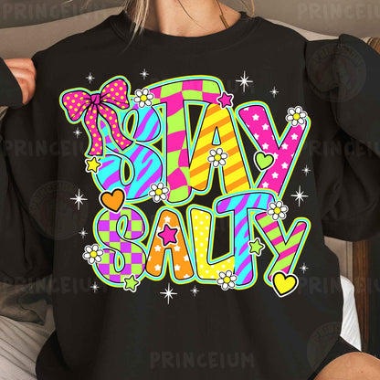 a woman wearing a black shirt that says stay salty