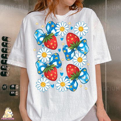 a woman wearing a white t - shirt with a strawberry and daisies on it