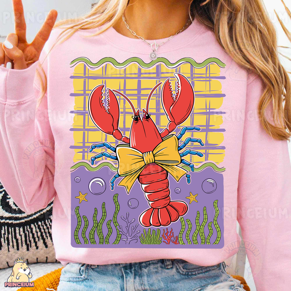 a woman wearing a pink shirt with a lobster on it